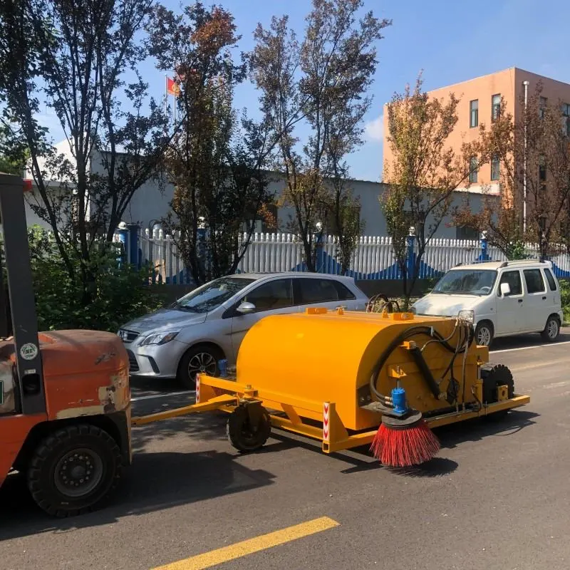 Towed trailer sweeper on site